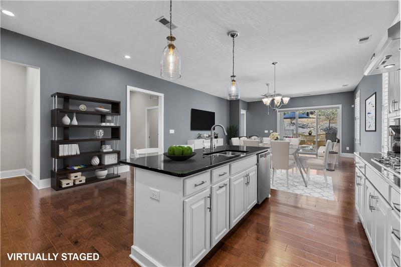 Kitchen:  features hardwood floors, recessed lights, roll-out shelving. (Virtually Staged)
