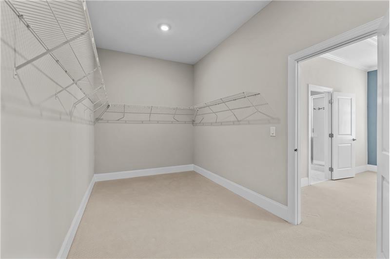 Primary Suite: oversized, walk-in closet  provides fantastic storage space, as well as direct access to laundry room.