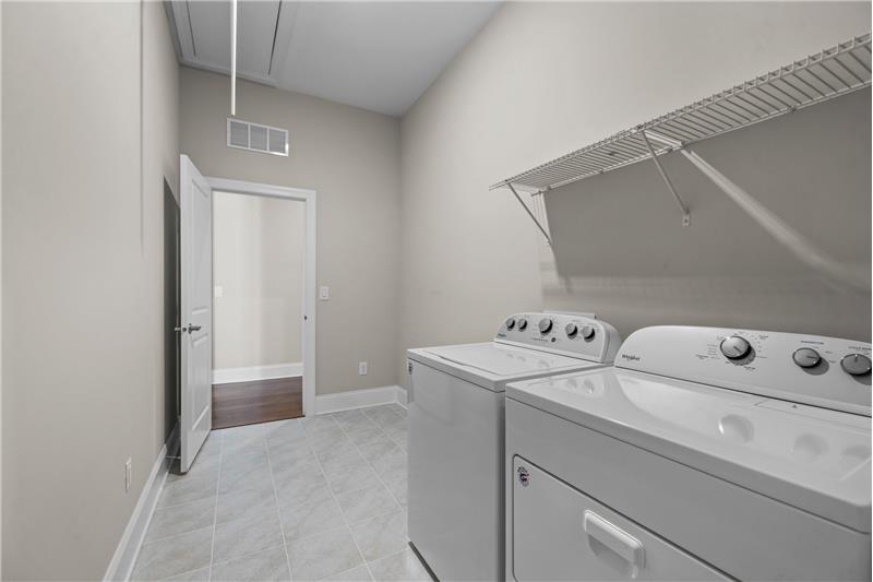 Laundry Room: Large laundry/utility room with access from both owner's closet and hallway. Washer/dryer convey.