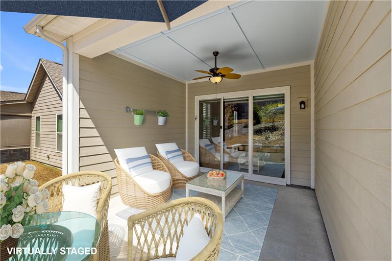 Covered Patio: accessed via sliding glass door in home's living room. (Virtually Staged)