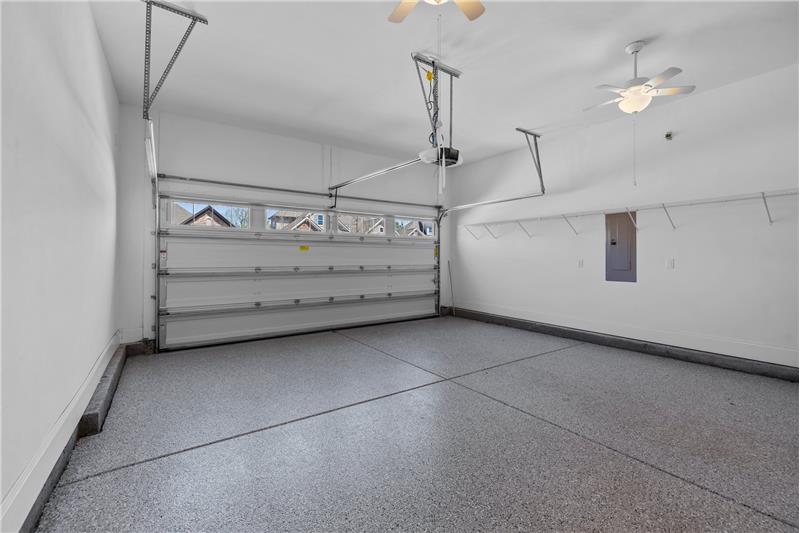 Garage: 2-car garage features epoxy flooring, shelving for storage, two ceiling fans with lights, automatic door opener.