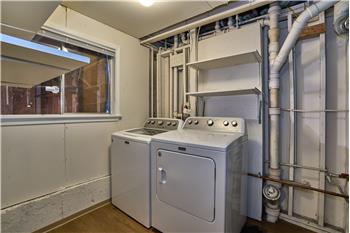 Utility Room Downstairs with Gas Hot Water Tank and Gas Furnace.