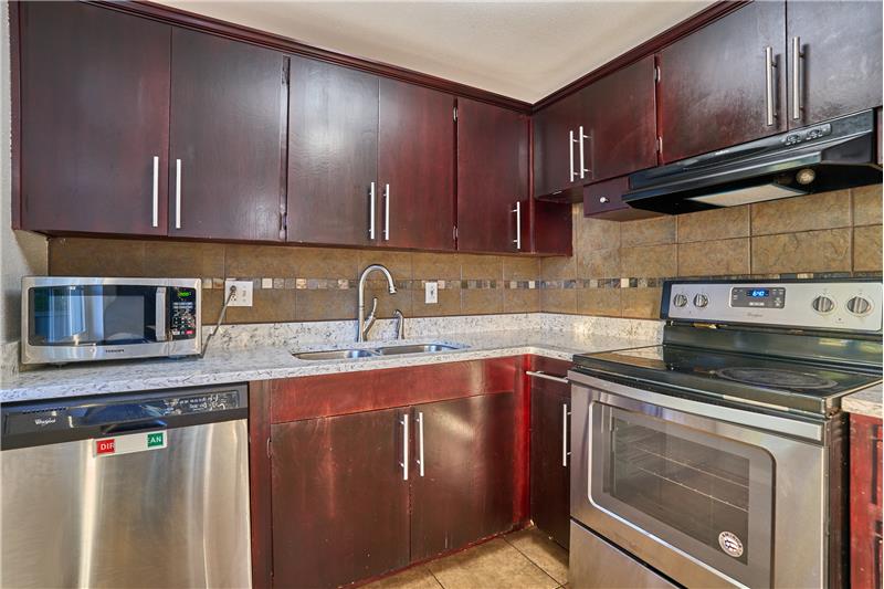 Chef's Kitchen with Granite Countertops, Stainless Steel Appliances, Granite Countertops, Tile Backsplash and Tile Floors.