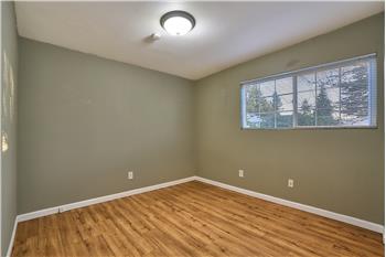 Main Floor Primary Bedroom with Laminate Floors.