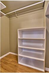 Main Floor Second Bedroom includes a Large Walk-In Closet and Lighted Picture Frame.