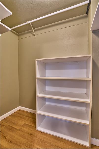 Main Floor Second Bedroom includes a Large Walk-In Closet and Lighted Picture Frame.