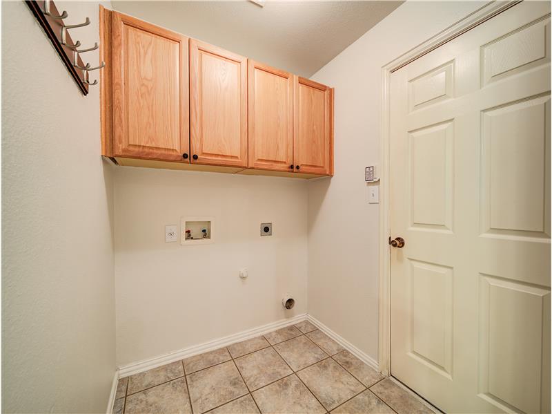 Large full size laundry space with storage cabinets