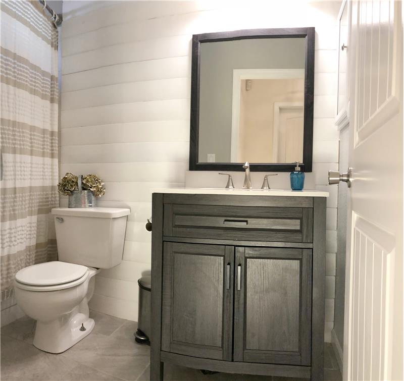 Guest Bath with shiplap and tile flooring