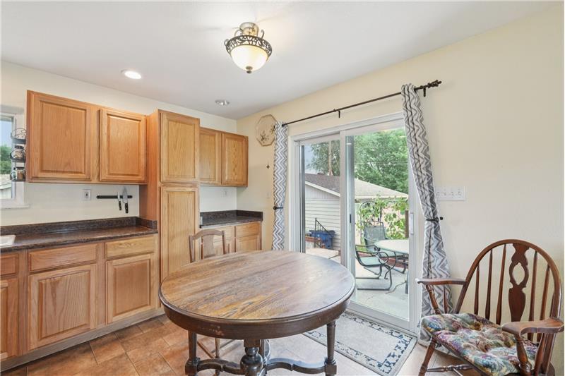 Eating area of kitchen with door to patio and garage