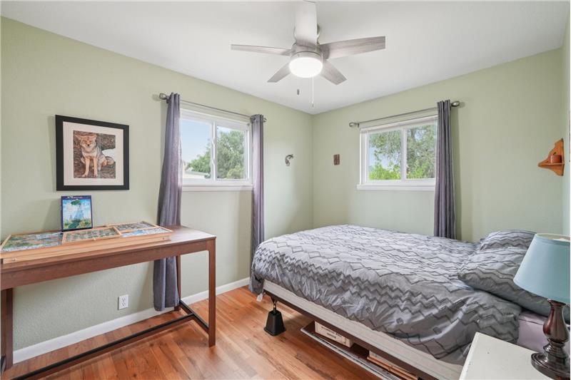 Guest bedroom with windows to side and back yards
