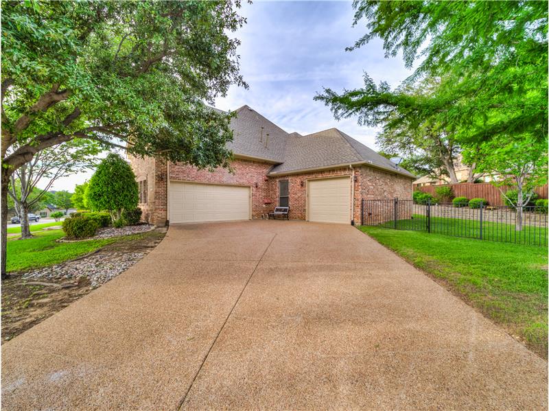 View of front of property featuring a garage and a front lawn