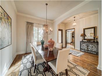 Dining area with dark hardwood / wood-style flooring, a notable chandelier, and ornamental molding