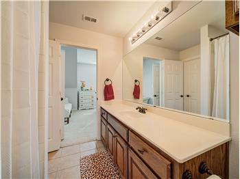 Upstairs Full Bath with two doors, to the bedroom and play/media room