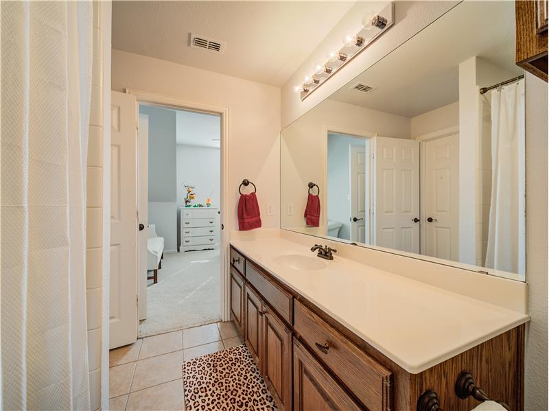 Upstairs Full Bath with two doors, to the bedroom and play/media room