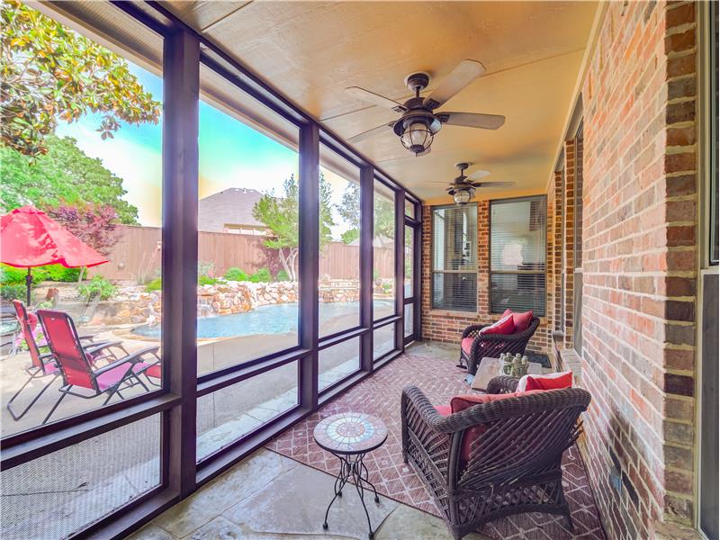Fully screened large covered porch with a view to the pool and spa