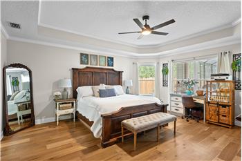 Owners Suite...Spacious with engineered hardwood flooring, step ceiling