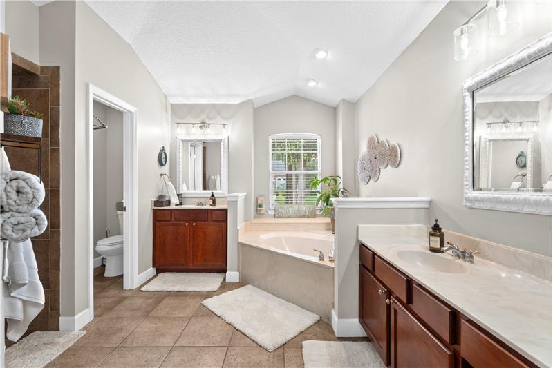 Soaking tub with his and hers vanities AND separate custom tiled walk-in shower