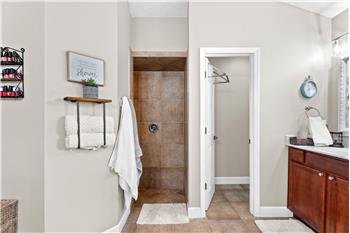 Soaking tub with his and hers vanities AND separate custom tiled walk-in shower