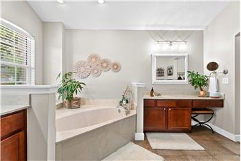 Soaking tub with his and hers vanities AND separate custom tiled walk-in shower