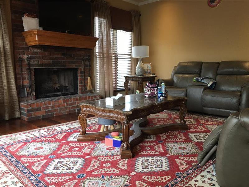 great room with wood burning fireplace adjacent to kitchen