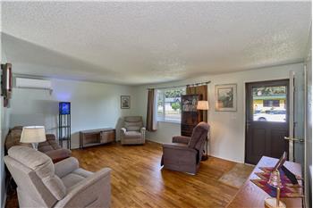 Lovely Living Room with Hardwood Floors and Wall Mounted Air Conditioner Unit.