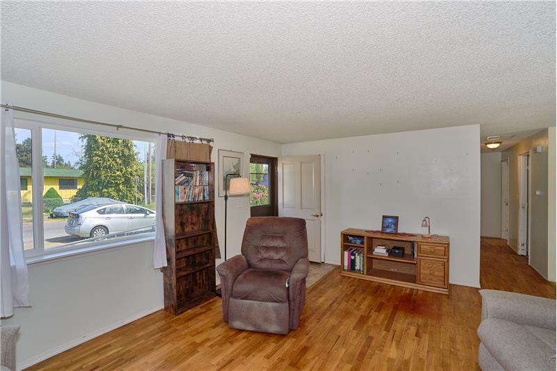 Front Entrance and View of the Living Room with Hardwood Floors.