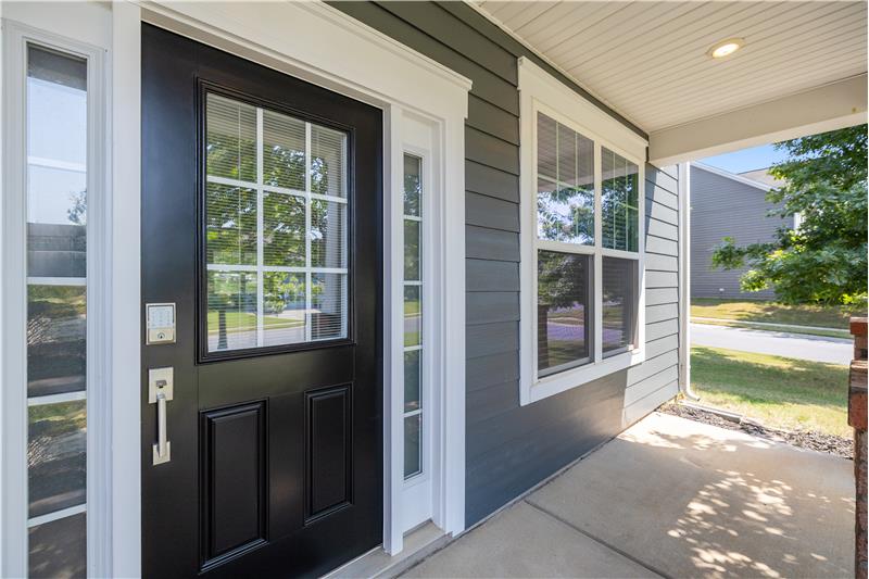 Inviting front entry with modern black door and sidelights