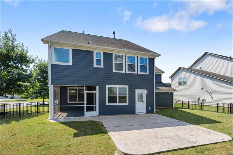 Back view of home with expansive patio