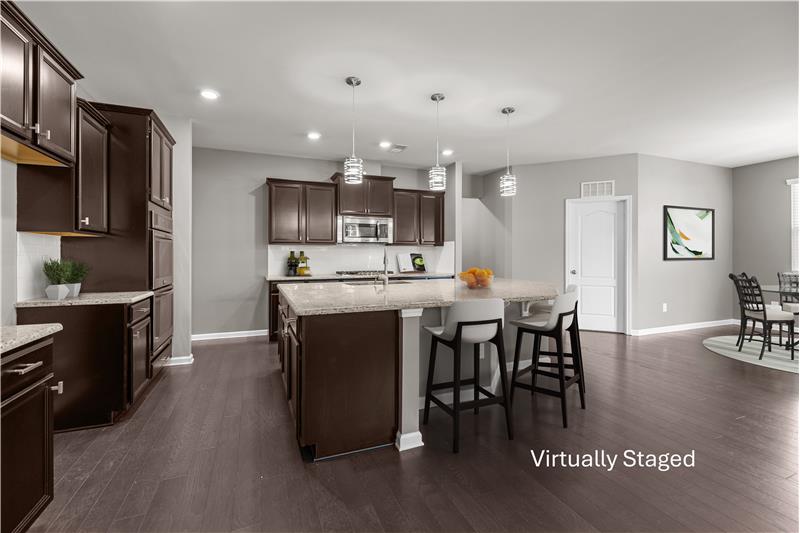 Stylish kitchen layout blending modern finishes, recessed lighting, and a perfect connection to dining and living spaces