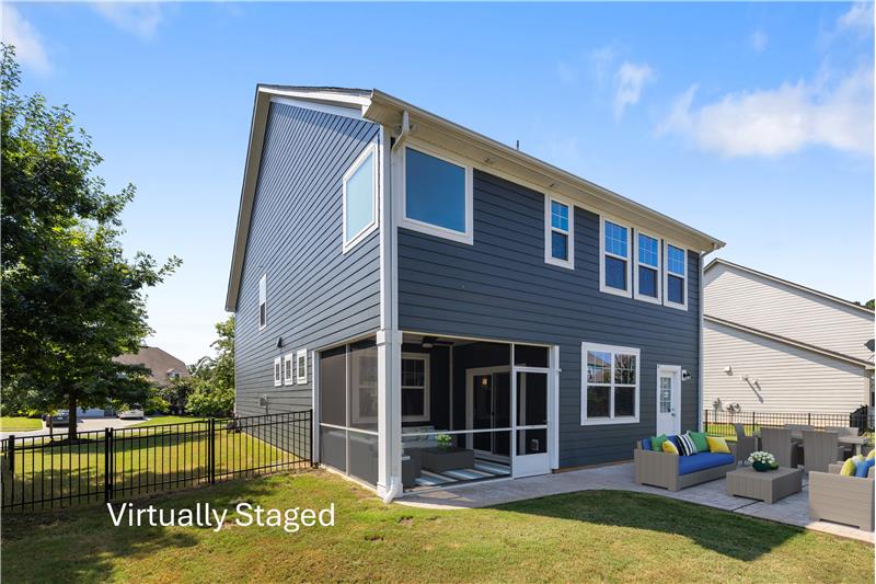 Side view of home, screened porch, paver patio