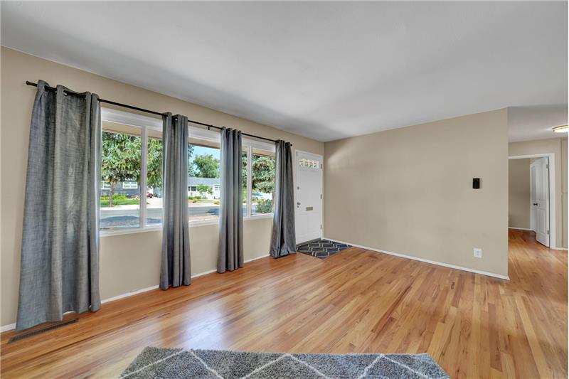 The Living Room has wood floors and a large picture window with views to the front yard