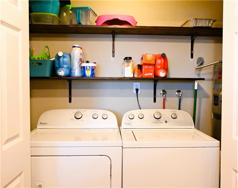 Both washer and dryer stay. New on demand wifi enabled 2 year old hot water heater to right of washing machine.