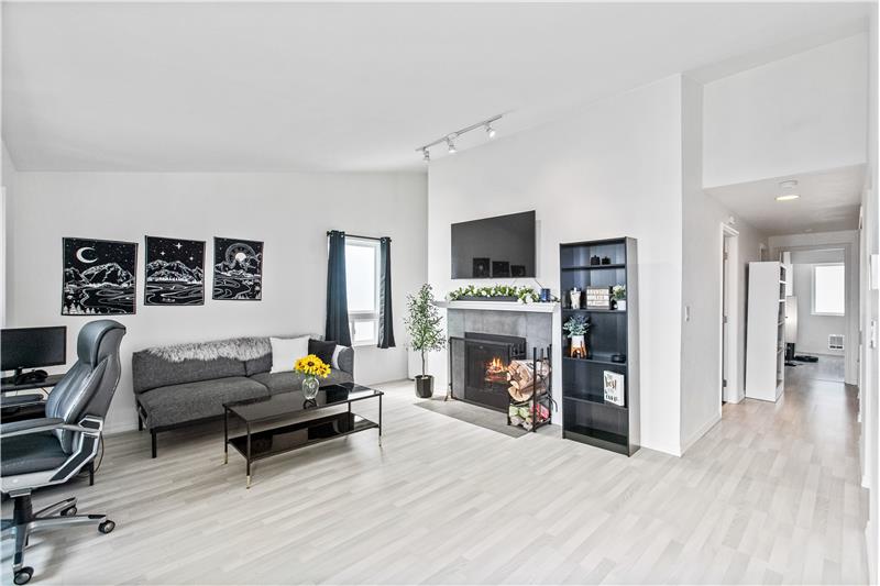 The home features newer plank vinyl flooring in a lighter tone, adding a sleek and modern feel throughout.