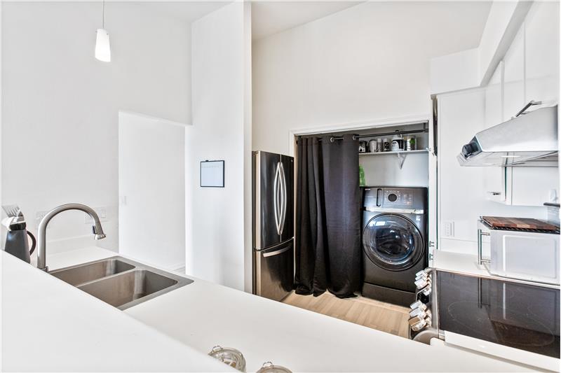 The appliance shown here stays with the unit. It is a washer/dryer combo, which adds a lot more room for pantry items and storag