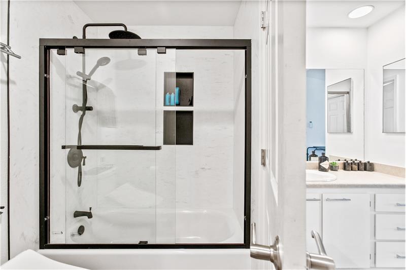 The shower includes a built-in niche for convenient storage.