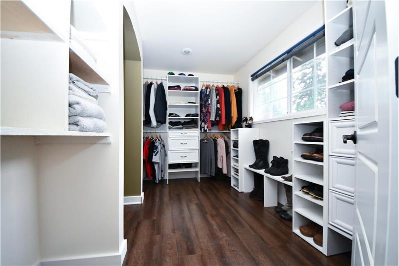 Master walk-in closet has custom California style shelves and cabinets.