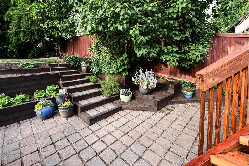 Garden area/paver patio at base of back deck steps.