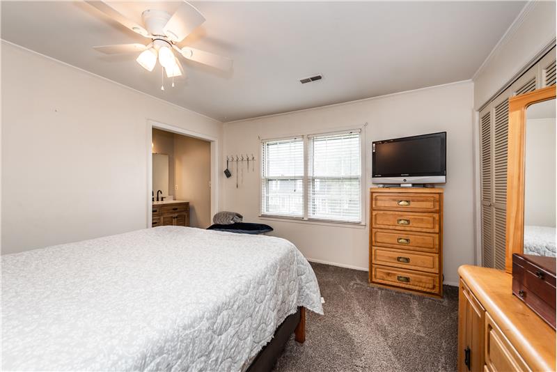 Owner's suite features brand new carpet, ceiling fan, fresh paint, double closet.