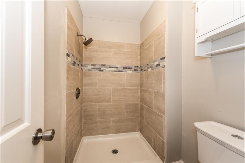 Brand new tiled shower (glass door to be installed in early November); updated toilet, new tile floors.