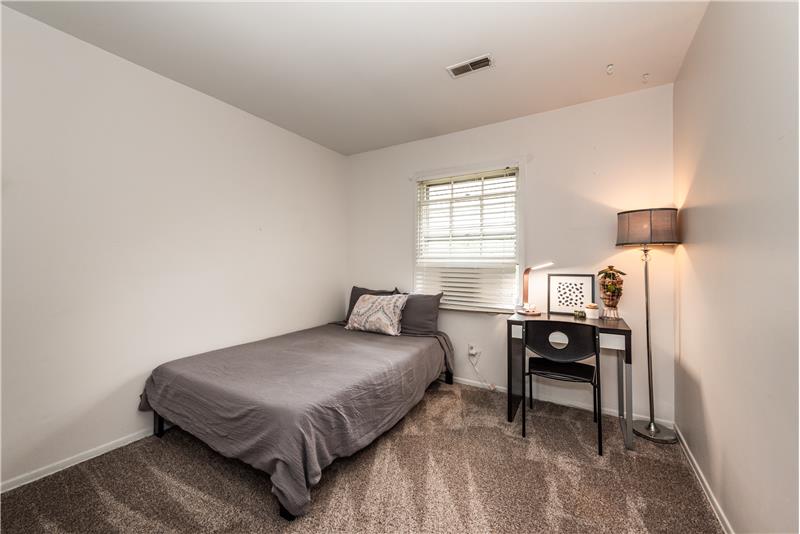 One of two additional bedrooms on home's second floor with brand new carpeting.