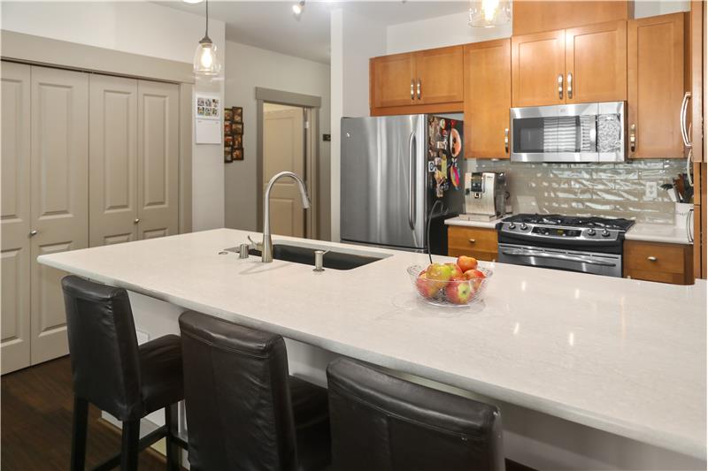 Open Kitchen includes Quartz Countertops, Custom Maple Cabinets, Gas Stove, Mosaic Glass Backsplash & Stainless Steel Appliances