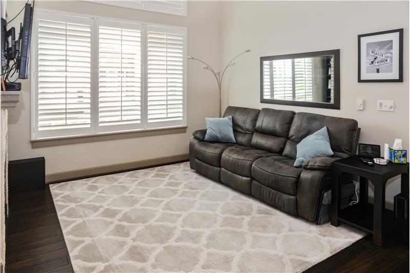 Cozy Living Room with 3 Inch Wood Shutters and 12 Foot Ceiling.