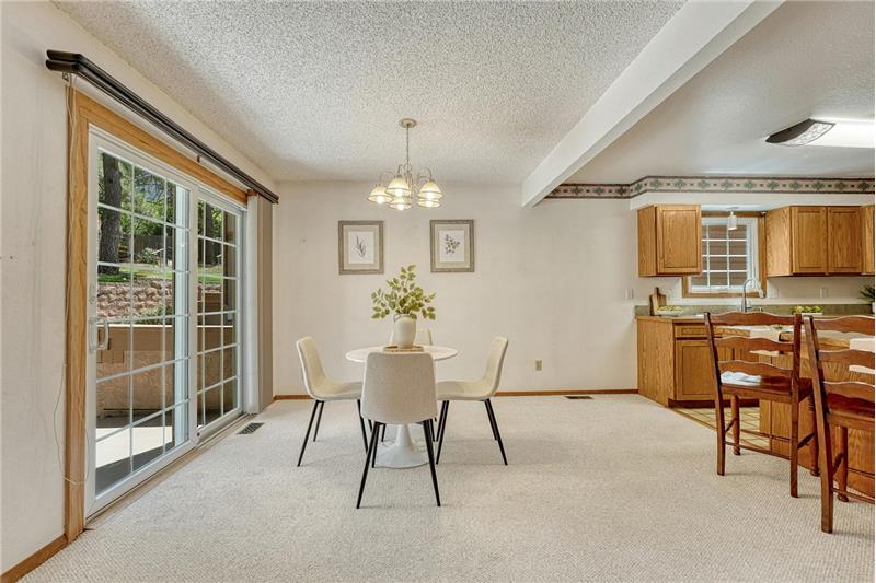 The dining area provides indoor-outdoor living with opening to the front courtyard, perfect for entertaining and outdoor dining.