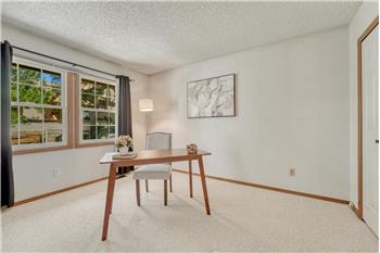 Upper Level Bedroom #2 (currently an office) has neutral carpet, large windows, and a generous closet.