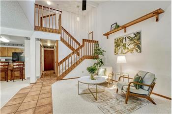 View of the entry, living room, and stairs to the upper level.