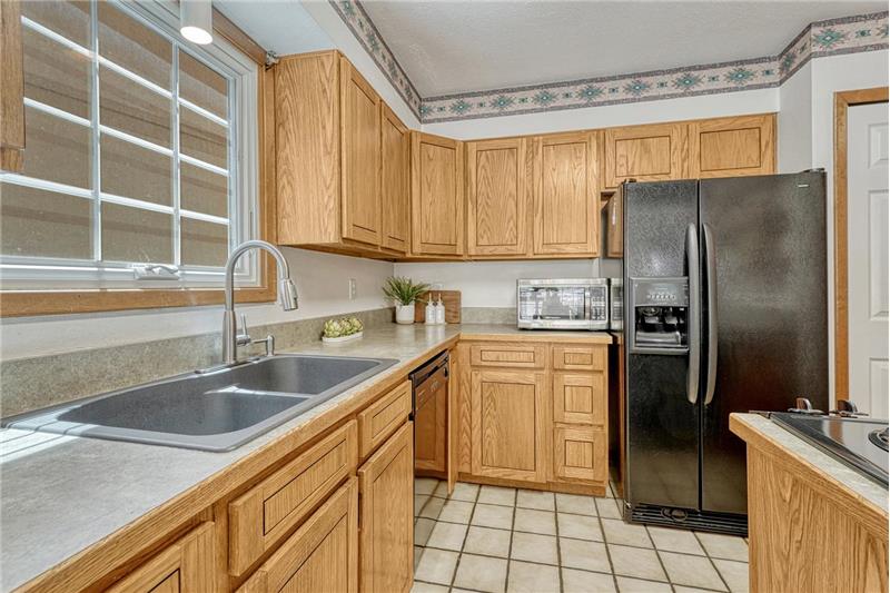 Inviting kitchen with two pantries, beautiful wood cabinetry and lots of counterspace for easy food preparation.