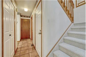 Hallway with garage access and stairs to the upper level.