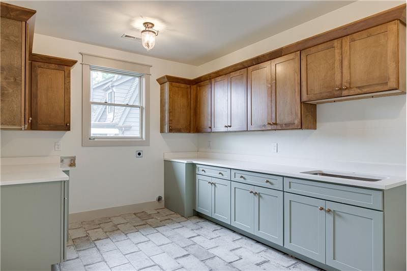 You've never seen a laundry room like this! plenty of cabinets room for extra refrigerators, hobby area, gift wrapping