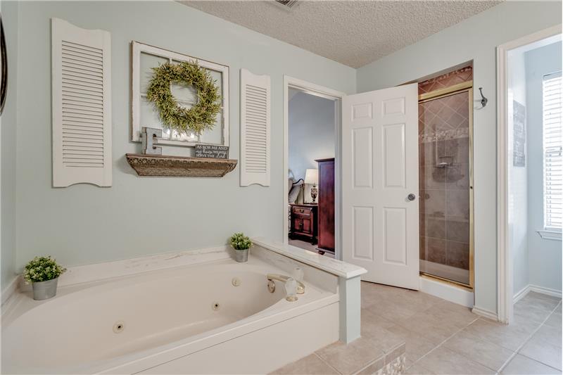 Master bath has separate tub and shower