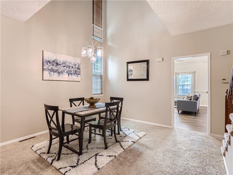 Spacious and bright dining room with vaulted ceilings and space for a very large table if so desired.